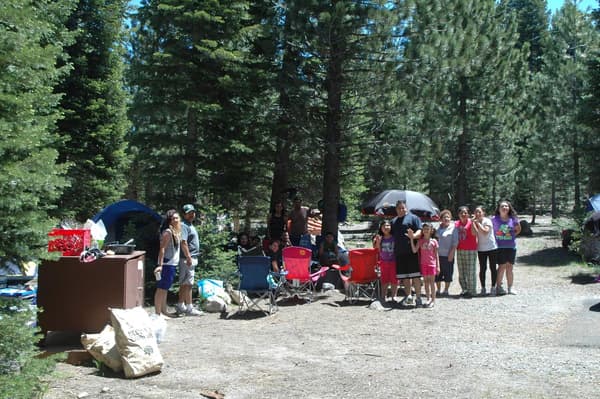 A large group of people pose for a photo at a campsite. - NPS Photo