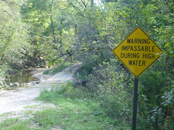 A sign warning visitors that Rush Creek can be impassable during high water. - NPS