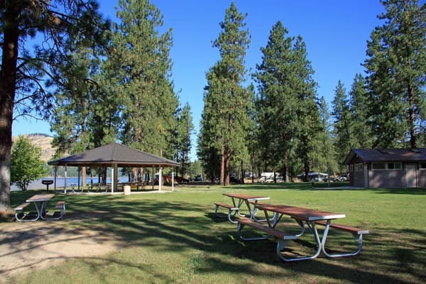 picnic tables in foreground, covered picnic area in background - NPS Photo