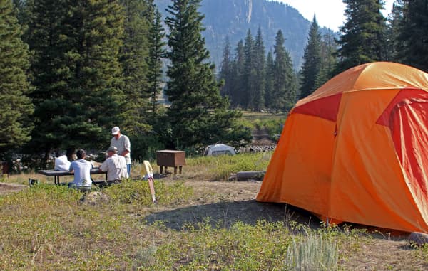 Visitors and tent at campsite. - NPS