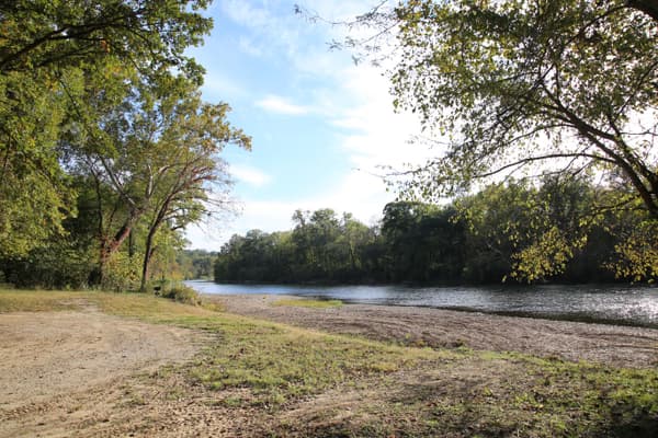 A grassy campsite is only yards away from the river's edge. - NPS Photo / Wil Marischen