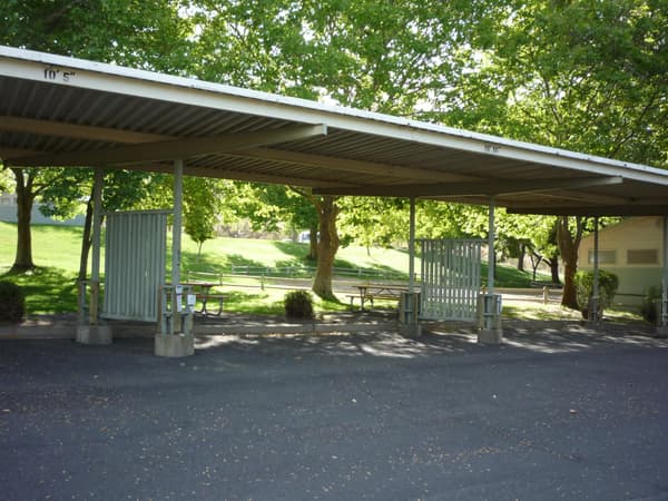 A paved and sheltered campsite area adjacent to the bathrooms. - NPS