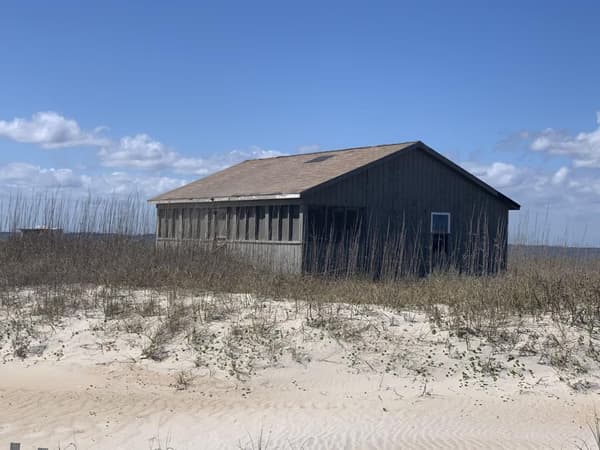Rustic wooden cabin sitting in the dunes - NPS photo/Jan Tugwell