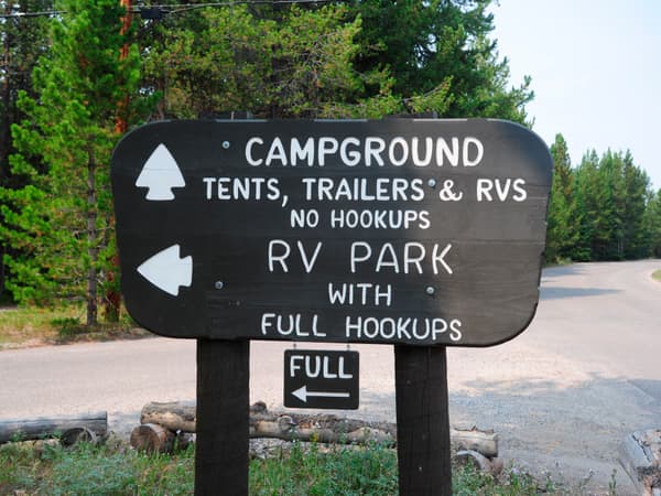 Brown wooden park service sign with campground information and RV park information - NPS Photo / Petersen
